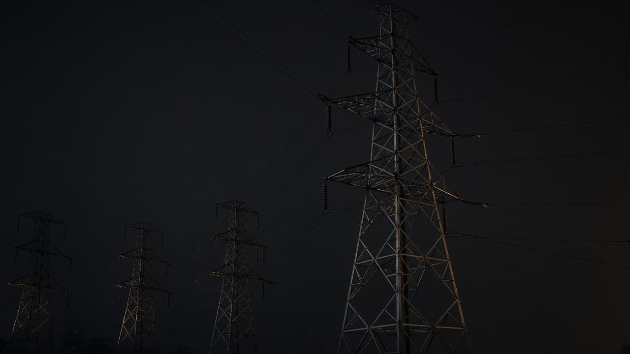Night-time power infrastructure silhouette